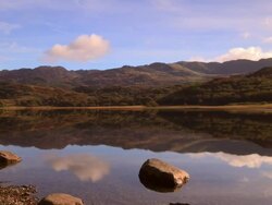 Time-Lapse Gentle pan across Llyn Dinas showing water reflections of clouds and countryside. Stock Footage