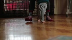 Mother learning baby how to walk Stock Footage