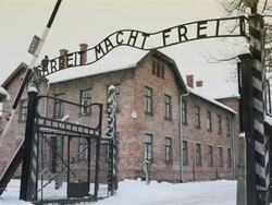 MS Shot of Main entrance gate at Auschwitz with snow rain / Auschwitz-Birkenau, Krakow, Poland Stock Footage