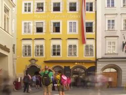 T/L Tourists in Front of the Birthplace of Wolfgang Amadeus Mozart in Salzburg Stock Footage