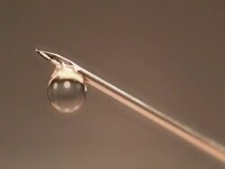 liquid medication exits from the needle of a syringe Stock Footage