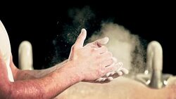 SLO MO Male gymnast clapping chalky hands together Stock Footage