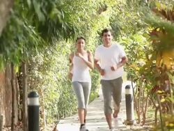 Couple running in a park  Stock Footage