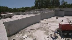 Mining equipment sits in a granite quarry. Stock Footage