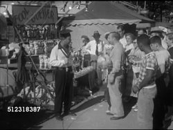 1952: COUNTY FAIR: VS The 'Manning' family playing 'Fool the Guesser' at carnival (SOT), male guessing young boy's weight, guessing wrong, young boy gets to pick a prize from stand. Funfair, festival, Maryland Instructional Video