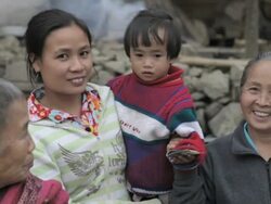MS women with child smiling / Xam Neua, Laos Stock Footage