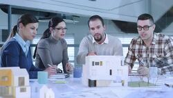 Young team in meeting collaborating on a building project Stock Footage