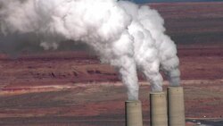 Smoke pours out of smokestacks at the Navajo Generating Station's coal-fired power plant in Arizona. Stock Footage