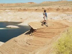 couple overlooking a desert lake Stock Footage