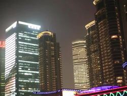 Traffic light and high buildings at night Stock Footage