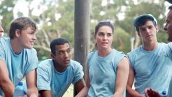 Team resting and talking at boot camp obstacle course Stock Footage