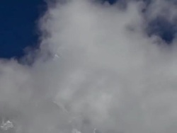 Time-lapse of clouds passing in front of a Himalayan peak. Cropped. Stock Footage