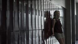 Medium shot of depressed girl walking and sitting in high school corridor / Mapleton, Utah, United States Stock Footage