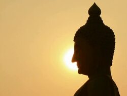 Sunset side big buddha statue silhouette Stock Footage
