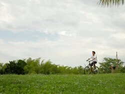 MS TS Man riding bike in rural area and dog following him / Quimbaya, Quindio, Colombia  Stock Footage