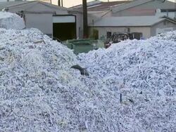 Late day shot of piles of trash and Corridor Recycling building Stock Footage