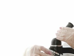 Biologist analyzing using microscope Stock Footage