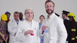 Scientists standing in front of diverse crowd with different careers Stock Footage