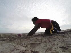 A group of young men playing flag football on the beach. - Slow Motion Stock Footage