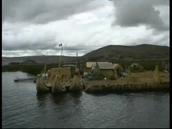 Boats moored near village, Lake Titicaca, MS, Peru Stock Footage