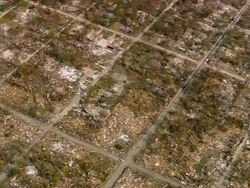 Aerial over destroyed house plots in residential neighborhood / Waveland, Mississippi Stock Footage