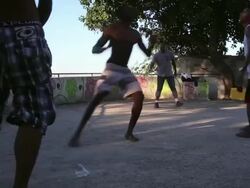 Group Of Local Residents Play Football In Mangueira Favela Stock Footage