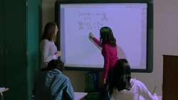 Teacher calls student up to use Smart Board Stock Footage
