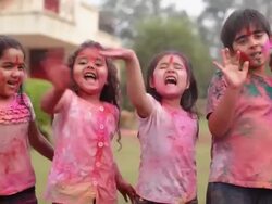 Group of kids celebrating holi festival in a lawn  Stock Footage