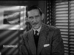 1953: Westbrook Van Voorhis ('The Voice of Time', 1903-1968) sitting on desk talking about election in November 1952, brought you preview in 'A Nation Decides' Instructional Video