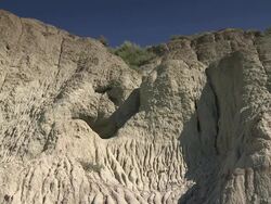A cliff in the prairies with a beuatiful blue sky Stock Footage