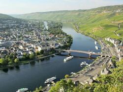 HA Boat traveling on Moselle river under bridge / Bernkastel-Kues, Rhineland-Palatinate, Germany Stock Footage