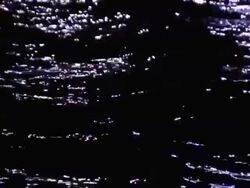 Lights reflect in waves rolling across the water. Stock Footage