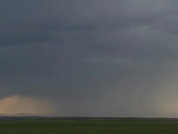 Forked lightning strikes ground under the base of a thunderstorm. Stock Footage