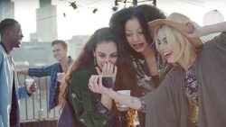 Playful young women taking selfie at urban rooftop party Stock Footage