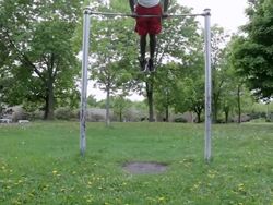 MS Young man doing pull-ups outside in park while working out / Minneapolis, Minnesota, United States Stock Footage