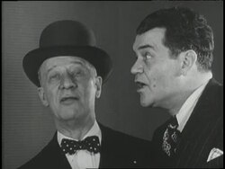 New York Governor Al Smith sings The Sidewalks of New York with another man as third man plays the piano. News Clip