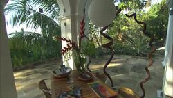 Unique potted plants decorate an outdoor dining area at the Smiths' Hotel. Stock Footage