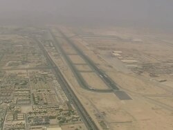 WS AERIAL ZI View of city and standing plane on runway / Qatar Stock Footage