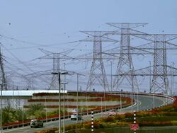 WS Traffic on highway surrounded by electricity pylons / Dubai, United Arab Emirates Stock Footage