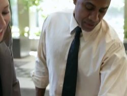  TD Business associates examining documents spread on a table / Seattle, Washington, United States Stock Footage