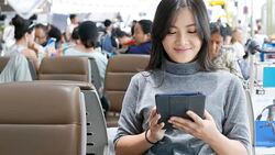 Woman use social media for communication at the airport Stock Footage