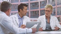 LD Male and female doctor in meeting with project manager Stock Footage