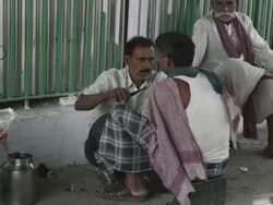 WS Street barber trimming mustasch on customer / Patna, Bihar, India Stock Footage