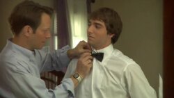 CU, Father tying teenage boy's (16-17) bowtie in front of mirror, Edison, New Jersey, USA Stock Footage