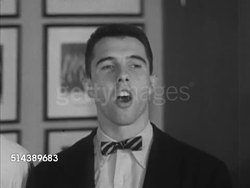 1953: YALE UNIVERSITY: VS Yale Students sitting outdoors by table, talking to each other, CU of book 'Society and Thought in Modern America.' VS Choir class singing traditional Yale song (SOT), male conductor. Instructional Video