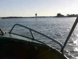 Starboard of Motor Boat Speeding towards Sunrise Across Water Stock Footage