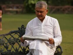 Two kids playing holi festival with his grandfather in a lawn  Stock Footage