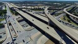 Aerial Over Austin Texas Highway and Interchange with vehicles driving during afternoon Traffic Stock Footage