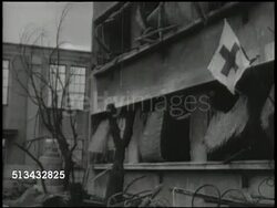 1945: DESTROYED JAPANESE CITIES: VS Demolished city rubble, destroyed landscapes, buildings. VS Damaged hospital ward, INT various Japanese doctors & nurses lifting patient on stretcher onto table, examining injured leg. World War II, WWII, aftermath Instructional Video