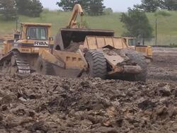 Caterpillar construction vehicles at a building site Stock Footage